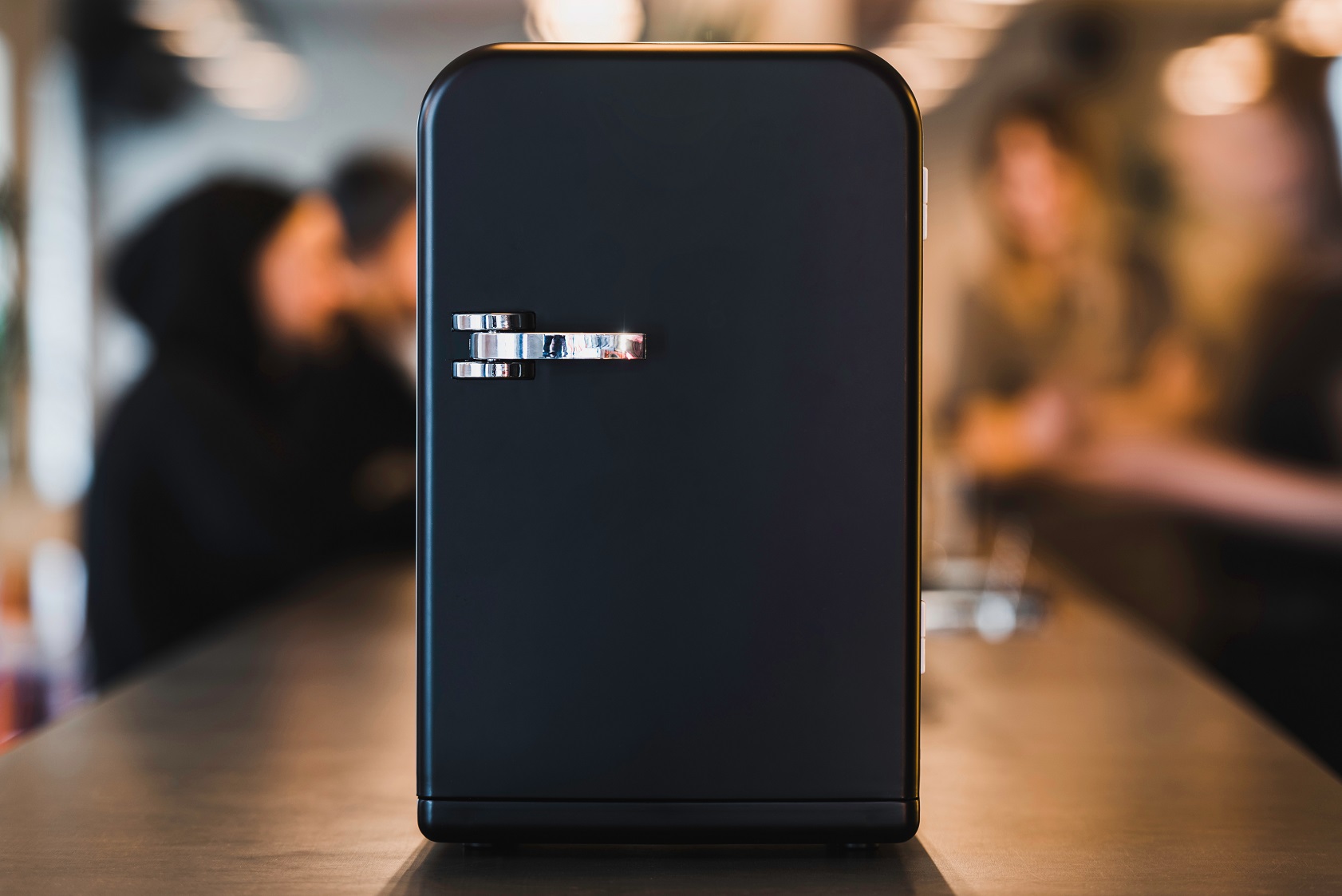 Small minibar refrigerator on the bar counter.