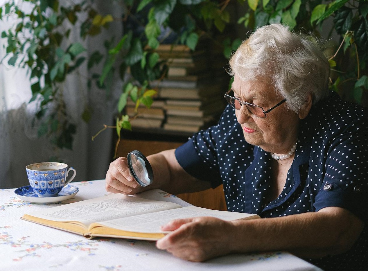 Elderly woman reading book