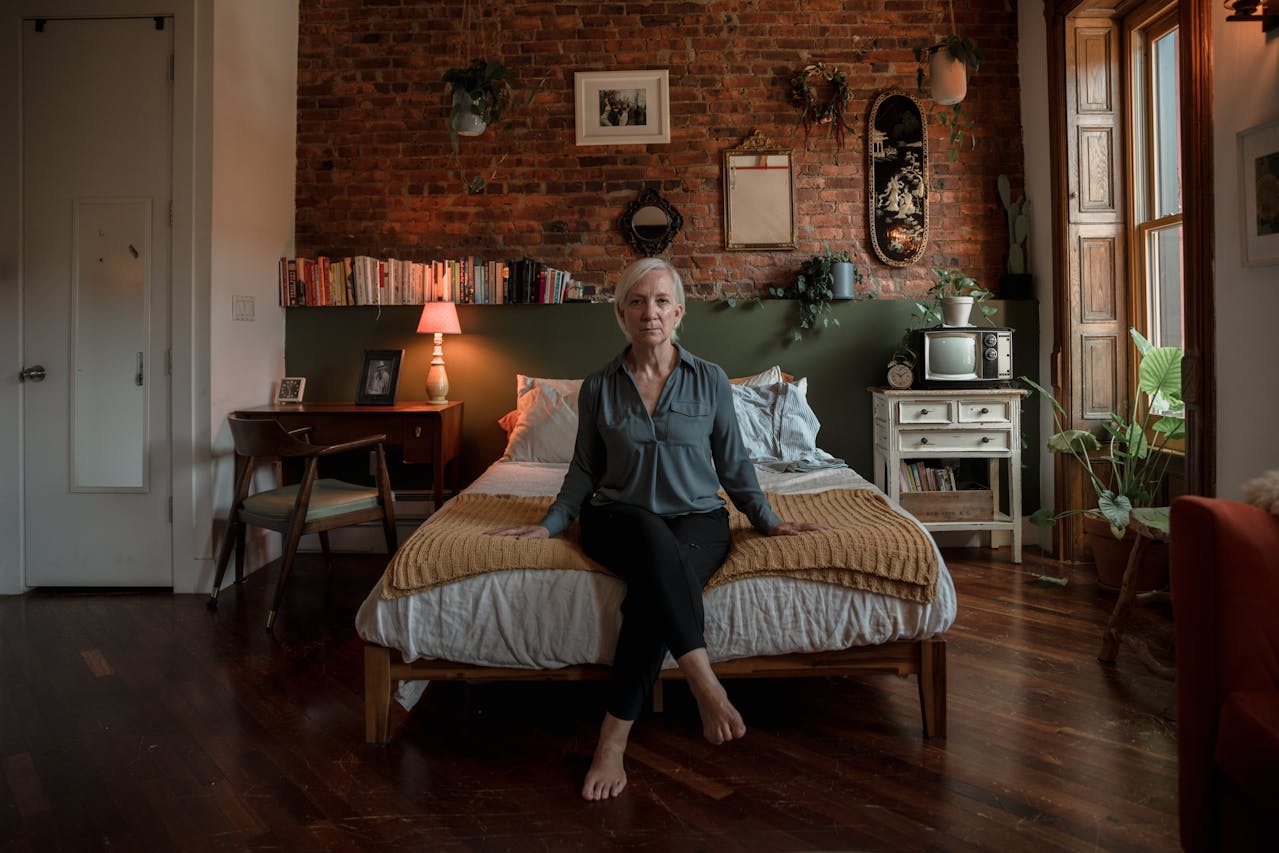 Woman Sitting on a Bed