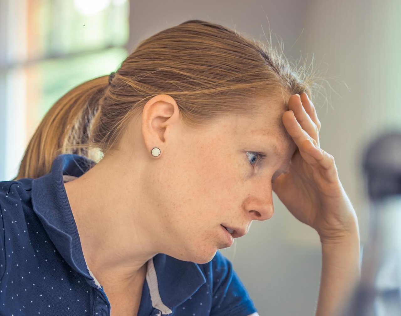Worried woman Sitting in Front of the Laptop.