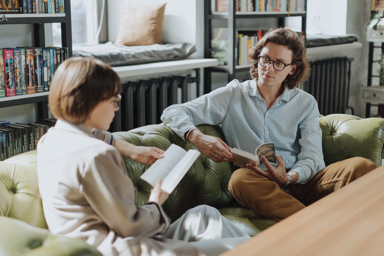 Couple in room are reading books.