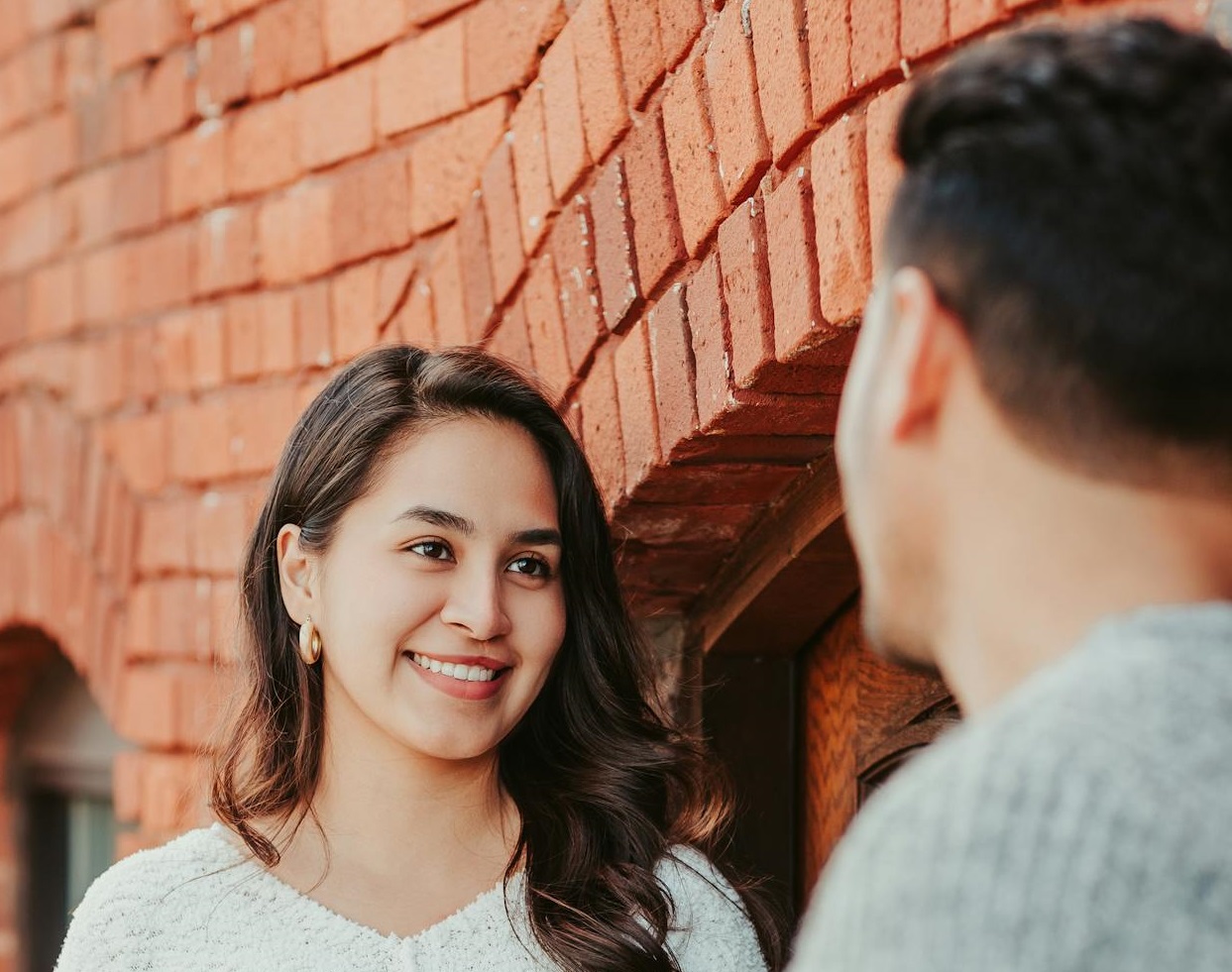 Couple standing near wall and talking
