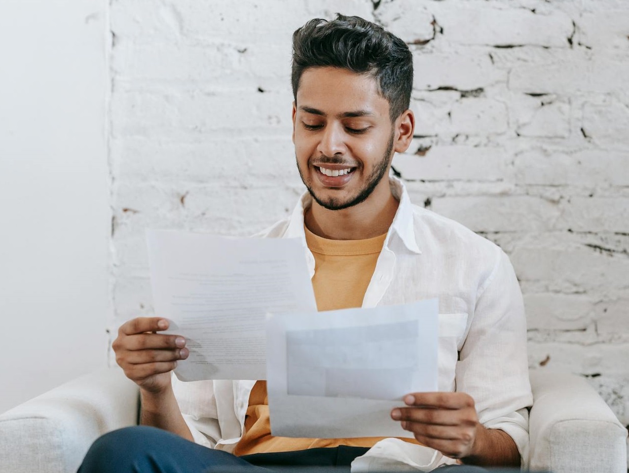 Man looking at documents and smiling.