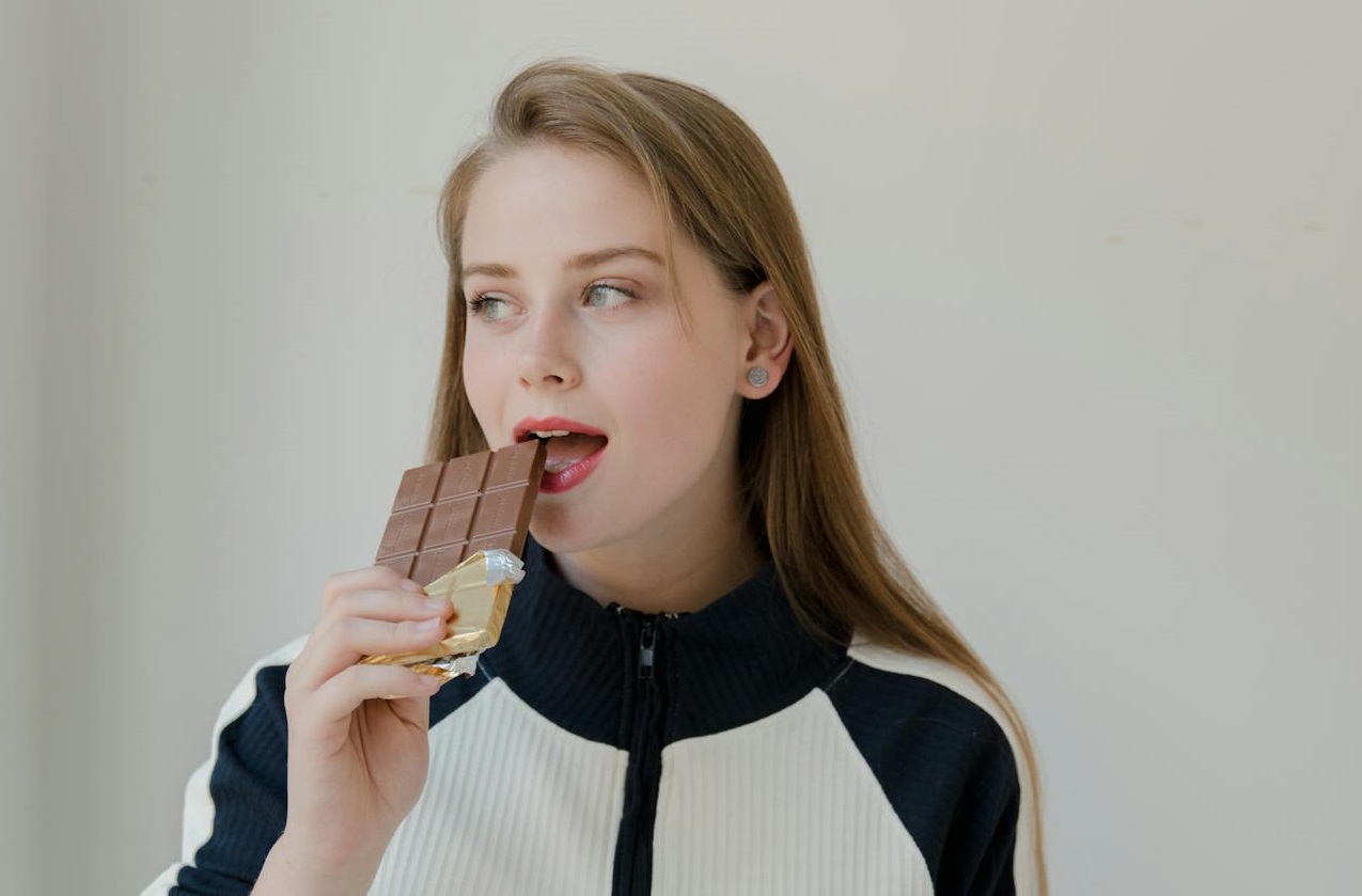 Woman Eating a Chocolate Bar