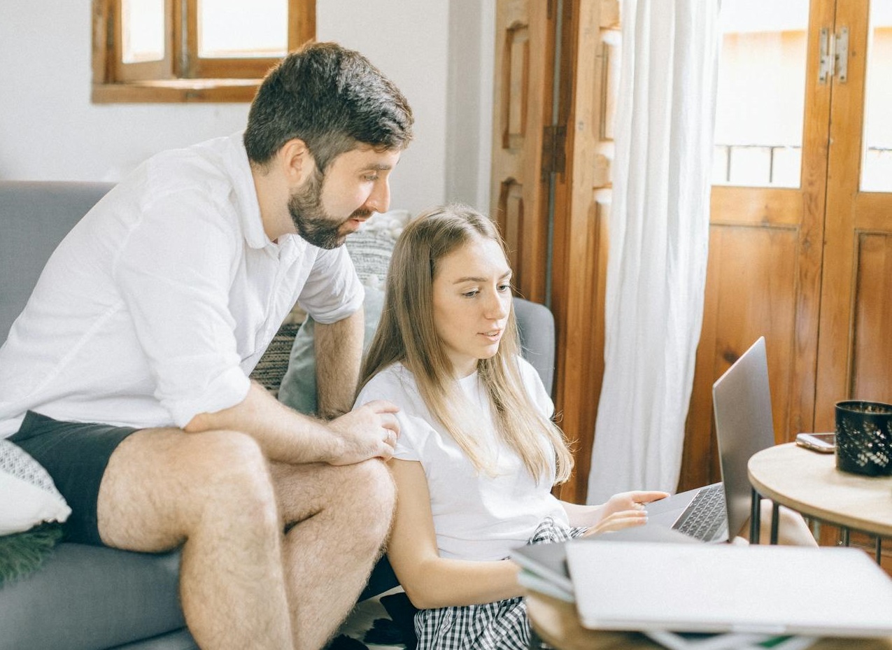 Man and Woman Looking at the Laptop