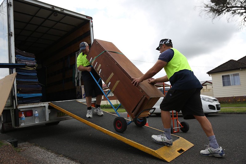 Photo of Movers Loading large items via the ramp into the removal truck