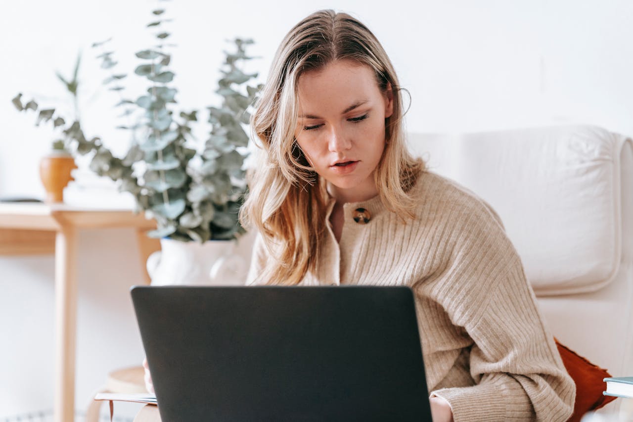 Busy woman working on laptop at home