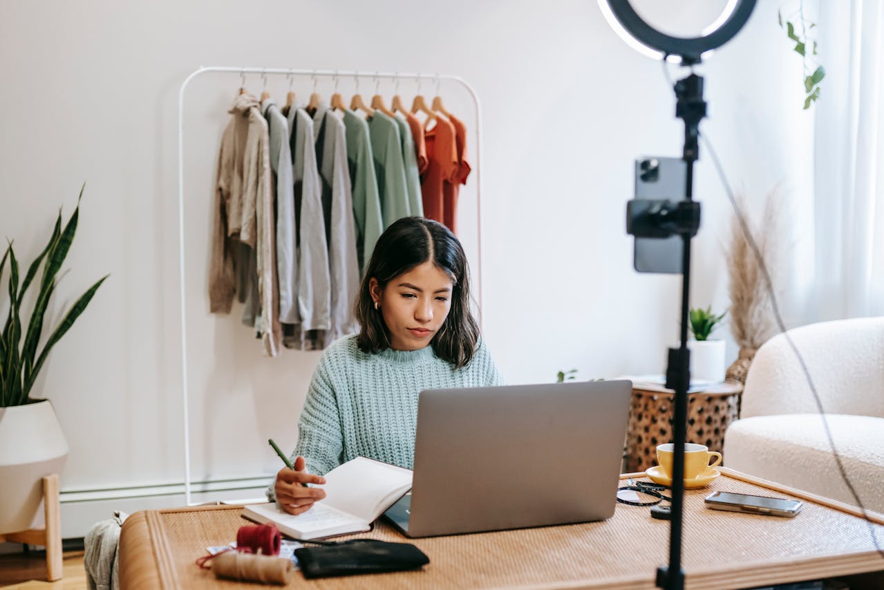 Focused blogger working on project at home, looking in laptop sitting on a desk