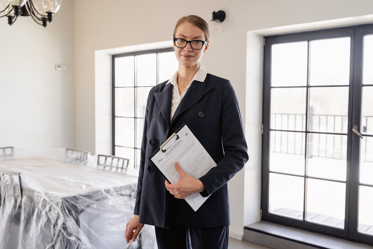 Portrait Photo of A Woman in Black Suit Jacket standing inside a house