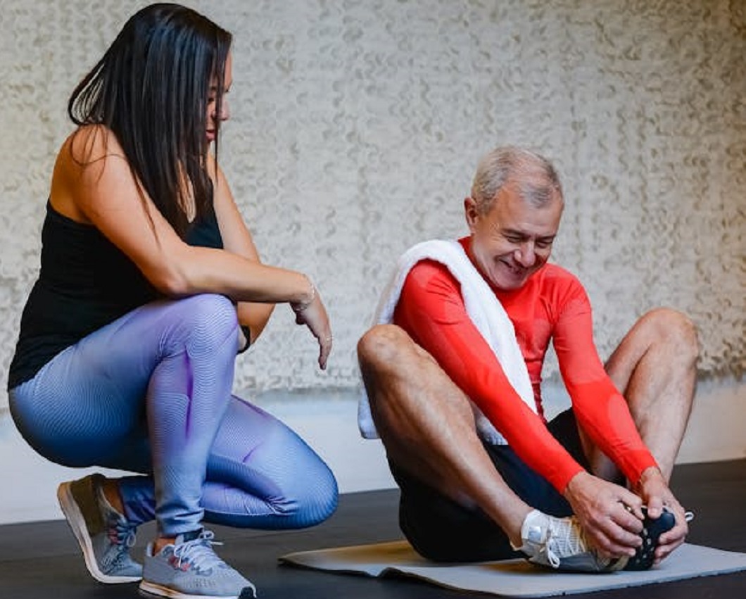 Person Doing Stretching Beside a Woman