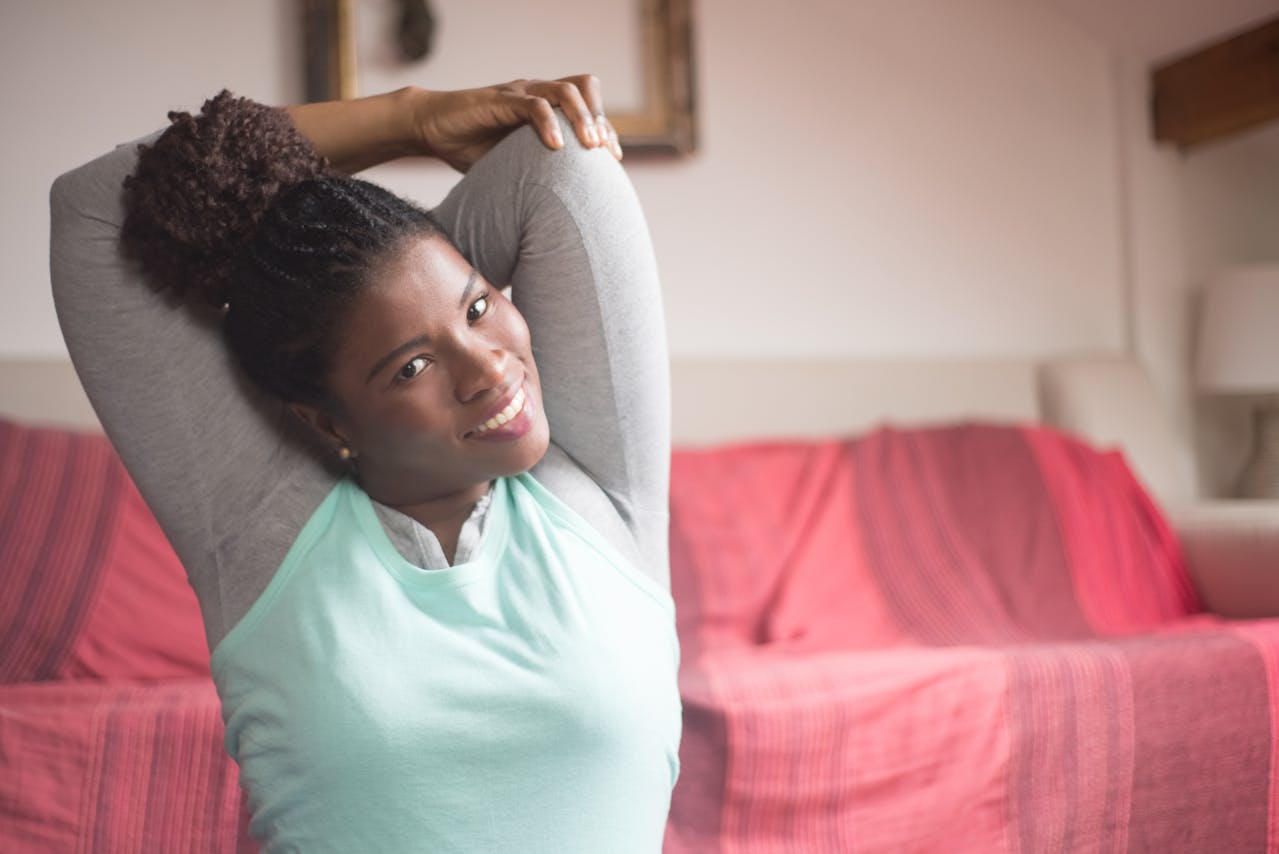 A Woman Smiling while Stretching Her Arms