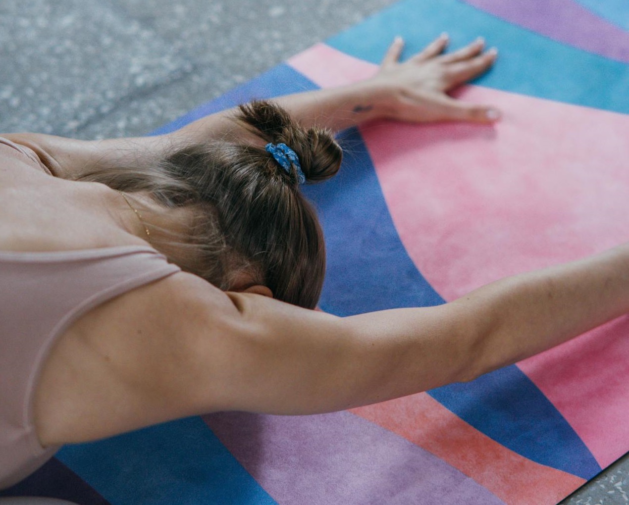 Photo of a Woman Doing Yoga on a Colorful Yoga Mat