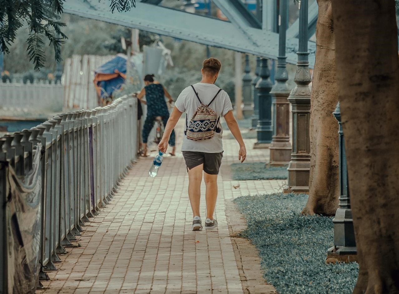 Photo of Man Walking on the street.