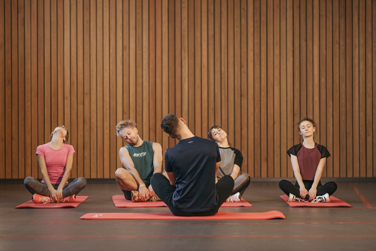 People Practicing Yoga Inside the Studio