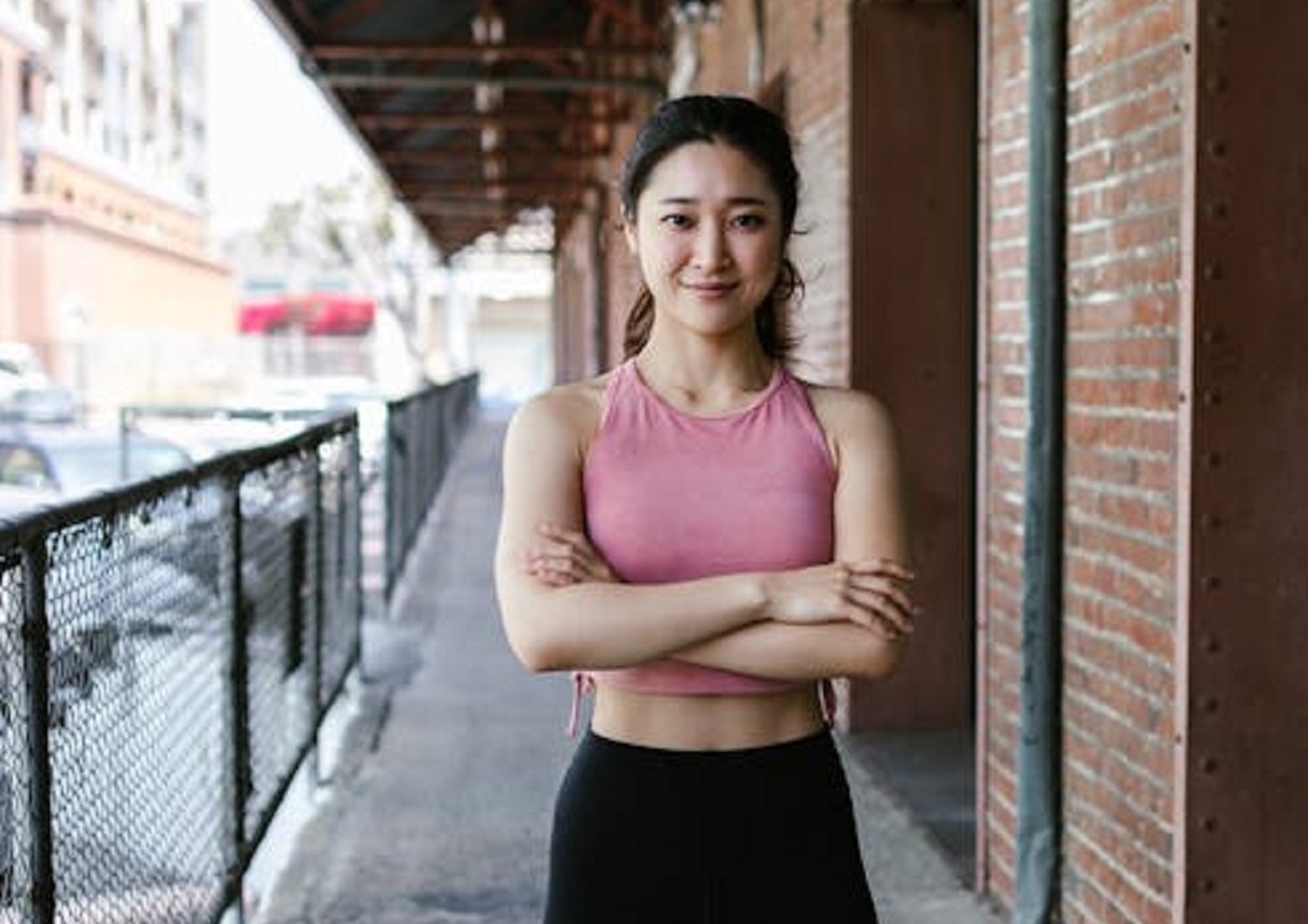 A Woman in Pink Tank Top looking at camera.