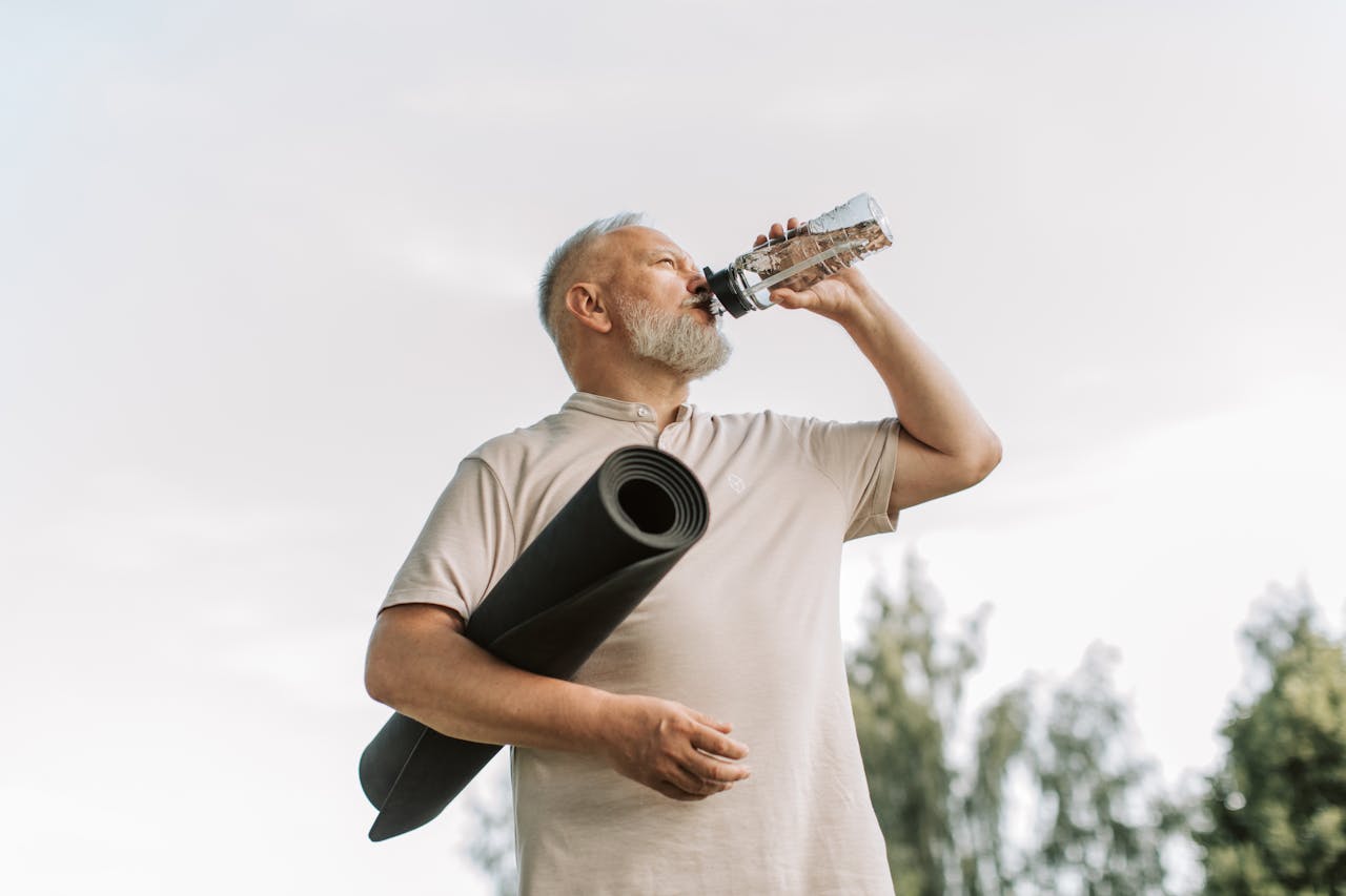 An Elderly Man Sipping Water from bottle