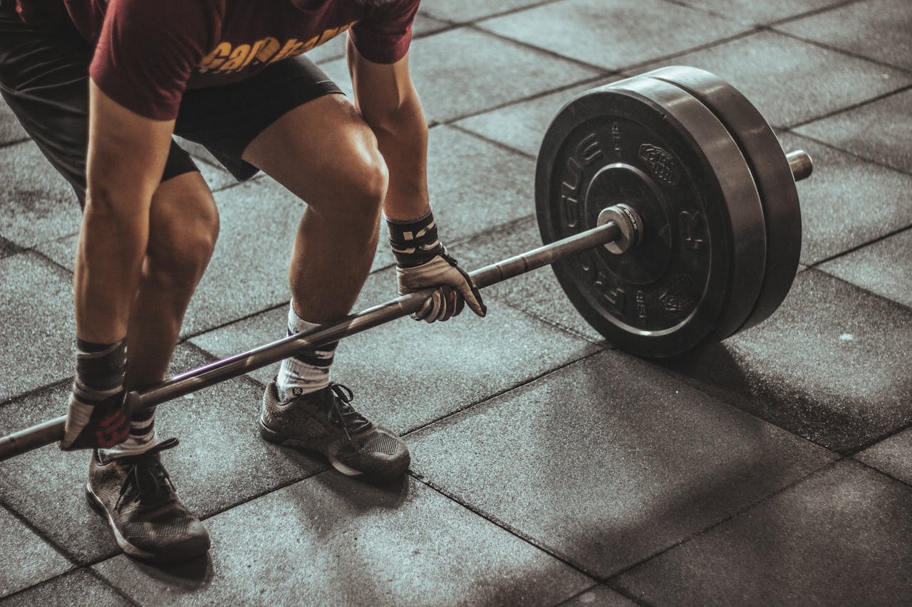 Person Holding Black and Silver Steel in gym