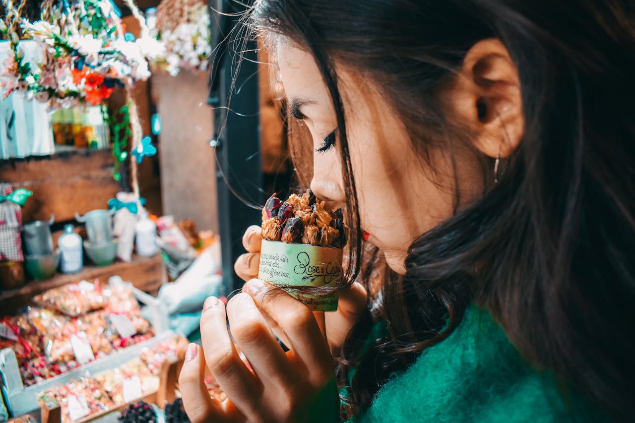 Woman Holding Brown Labeled Pack and smelling it