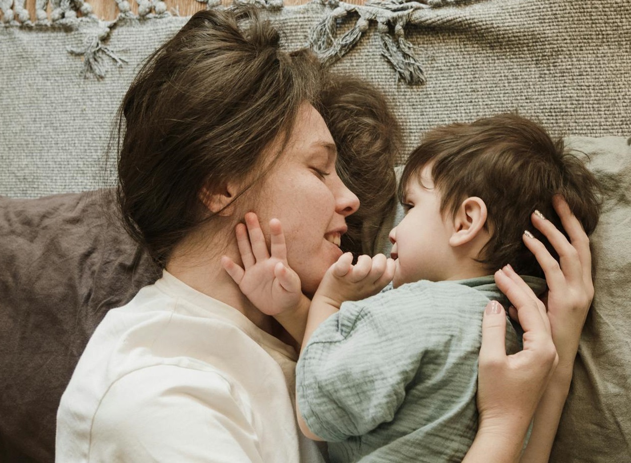 Young mother embracing her little son.