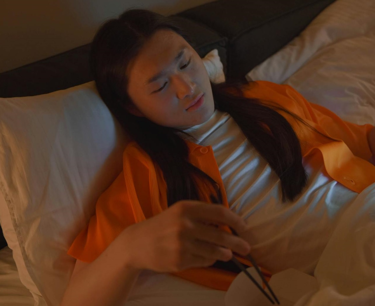 Sick man eating in bed.