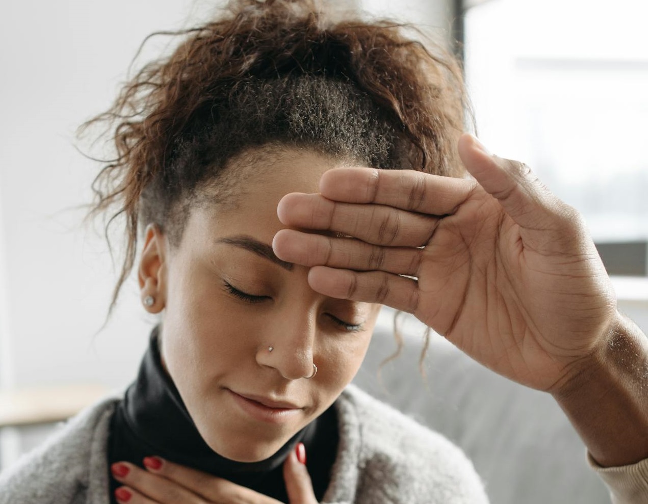 Person Touching sick Woman's Forehead
