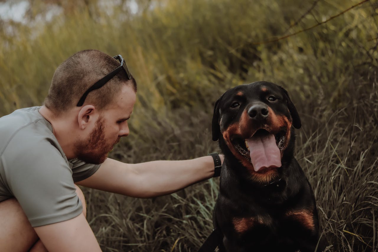 Photo of a Man Petting a Dog