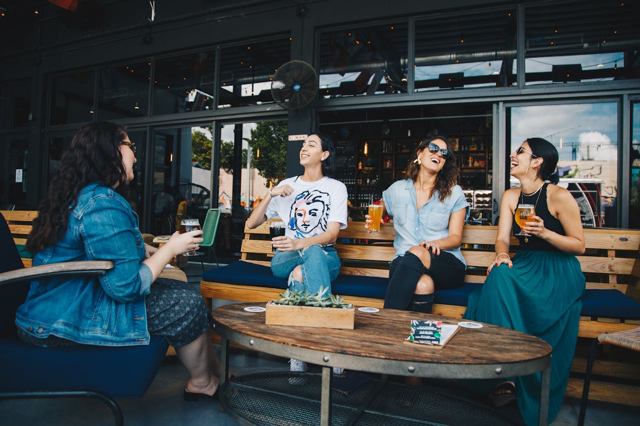 Four Women Chatting While Sitting at pub.