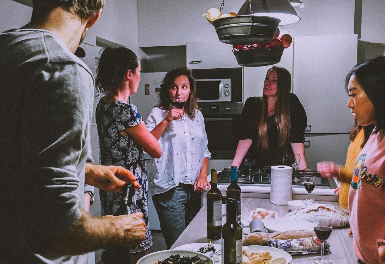 Men and Women Standing Infront of Dining Table