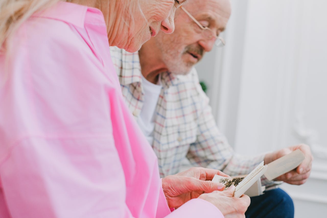 An Elderly Couple Looking at Photos Together