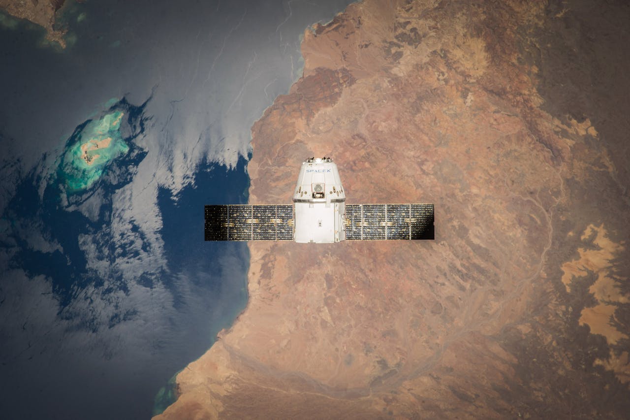 White and Black Satellite over the earth.