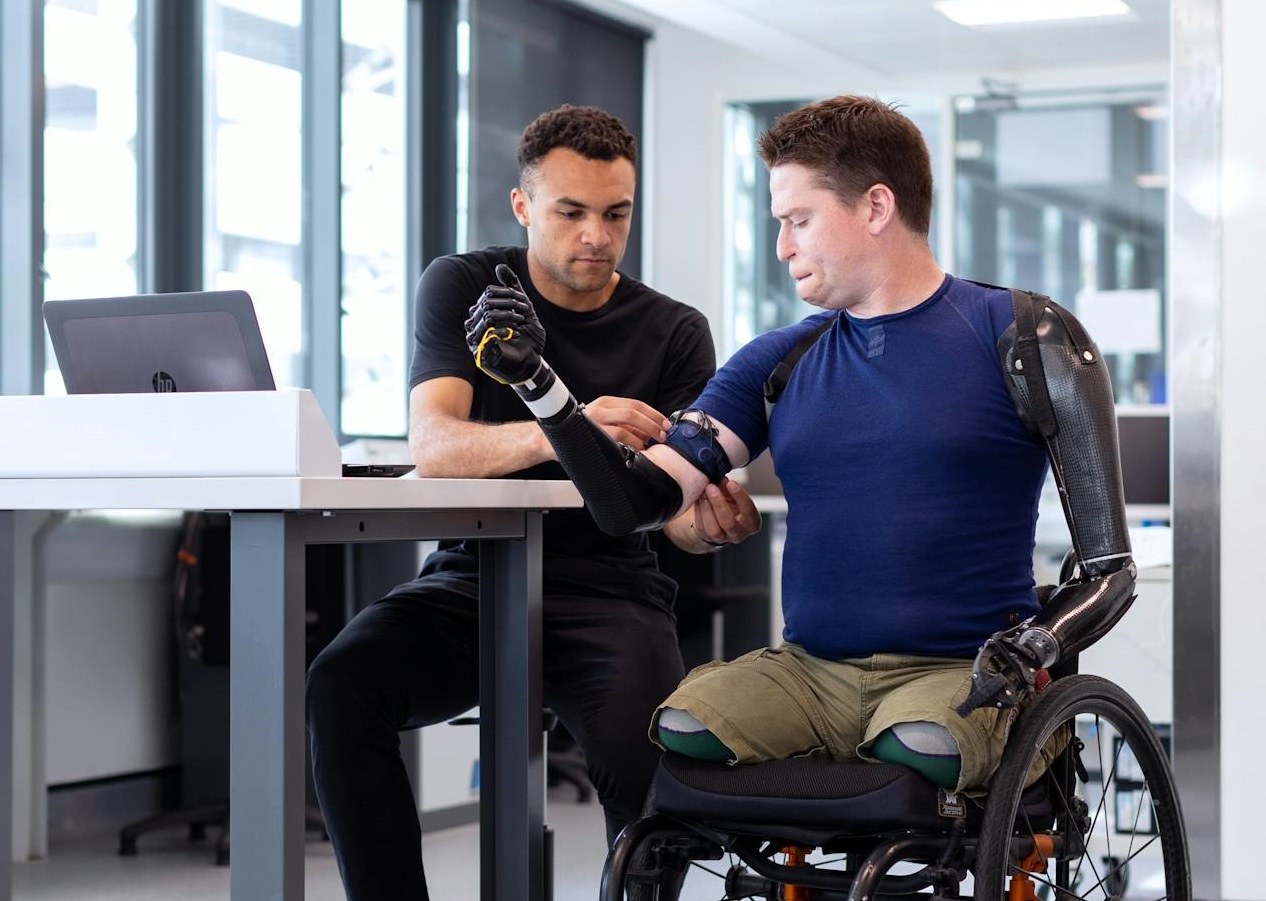 Engineer Fitting Prosthetic Arm