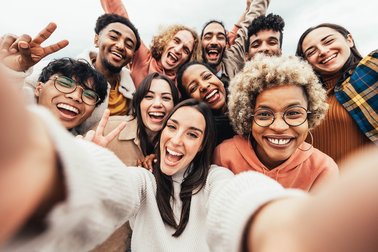 Big group of friends taking selfie picture smiling at camera