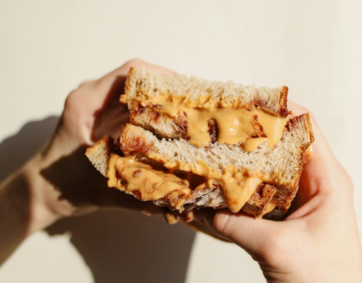 Person Holding Peanut butter sandwich.