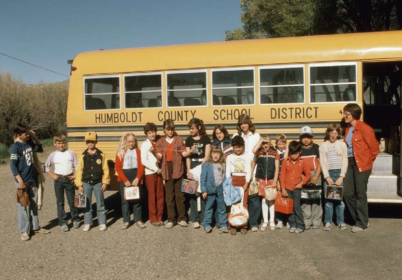 Public domain image of a school children Beside School Bus.