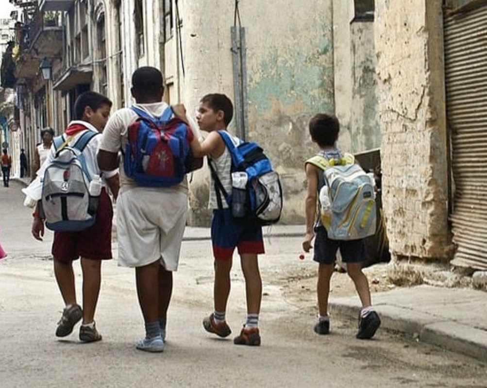 A group of children walking down a street.