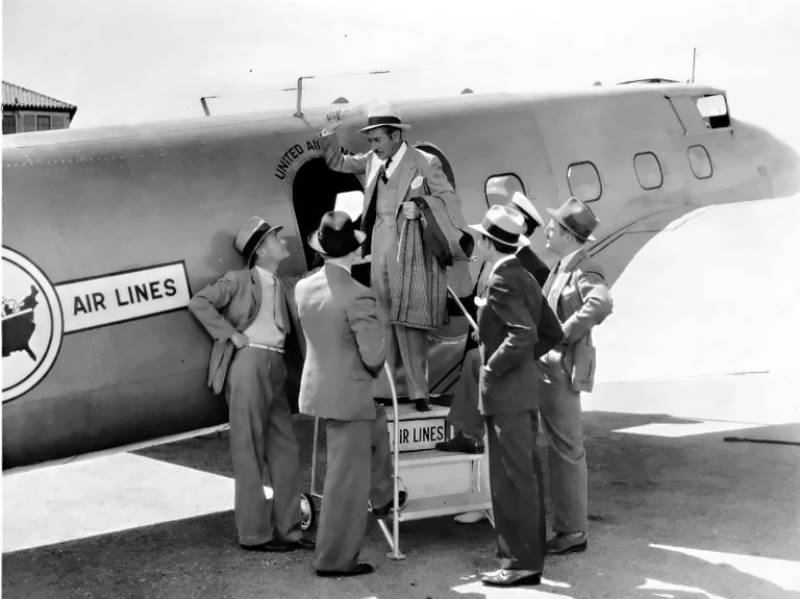 Man boarding United Air Lines Boeing 247 airplane