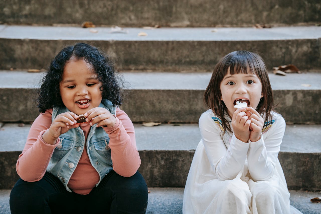 Kids eating cookies outside.