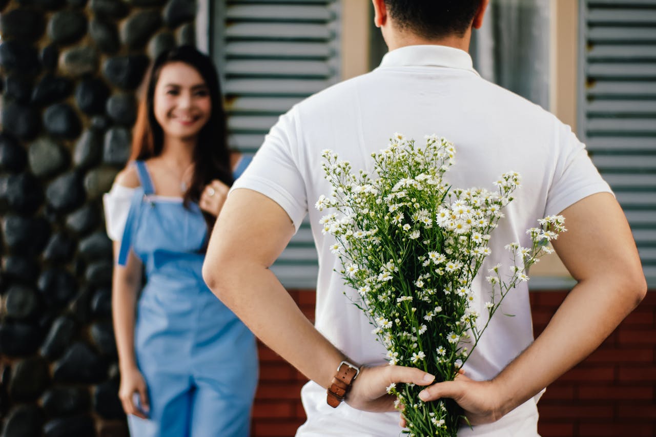 Man giving flowers to his girlfriend
