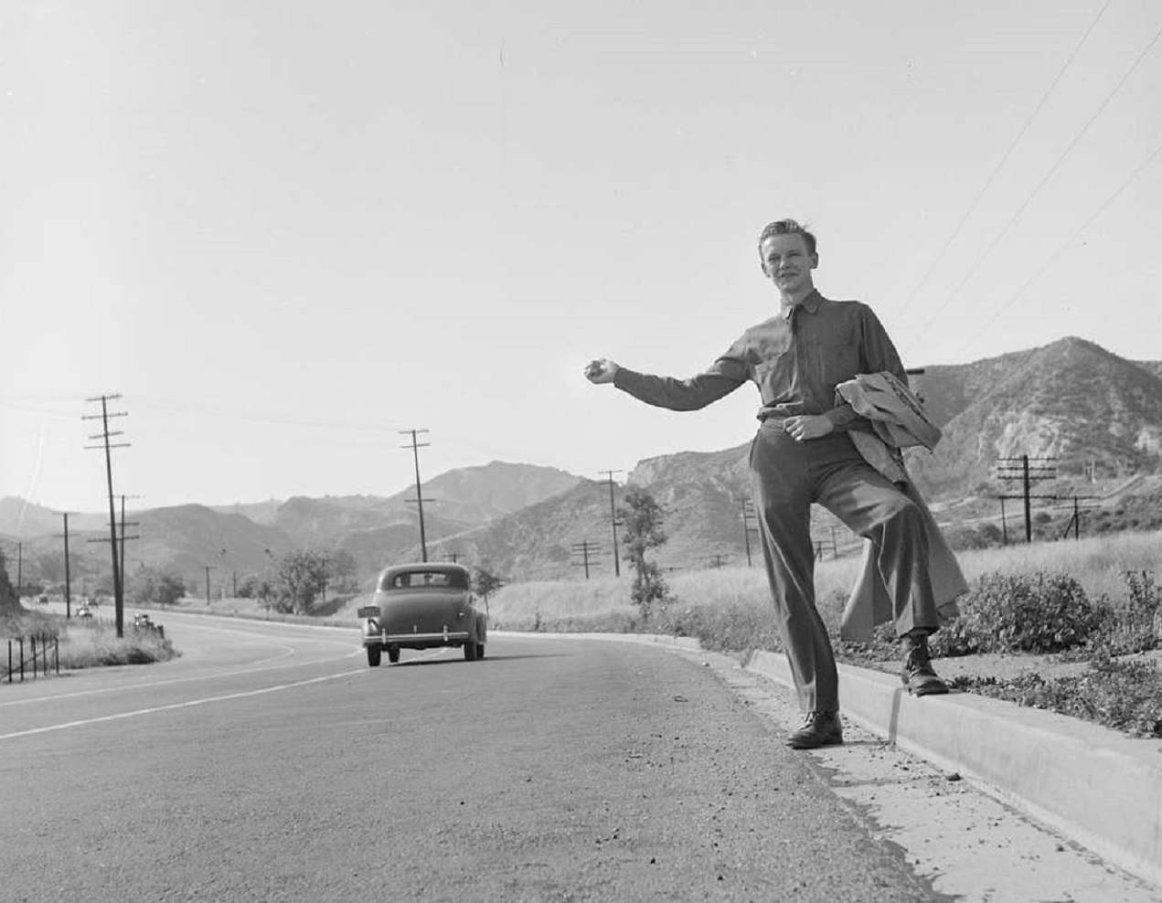 Young man is Hitchhiking - 1940s