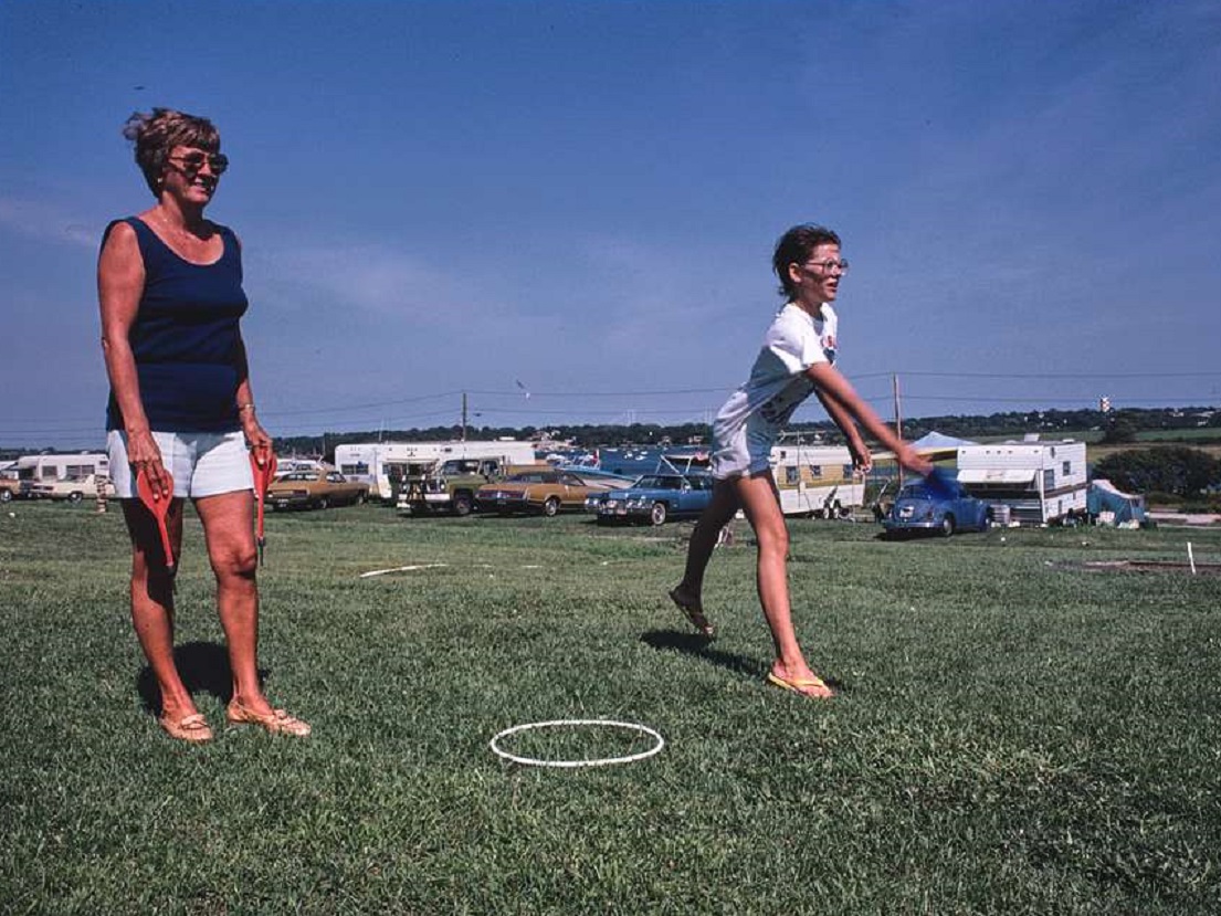 Women playing lawn darts outside - 1979