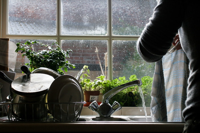 image of a woman cleaning pots