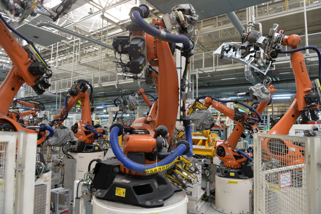 Robotic arms work on the assembly line at the Tianjin plant