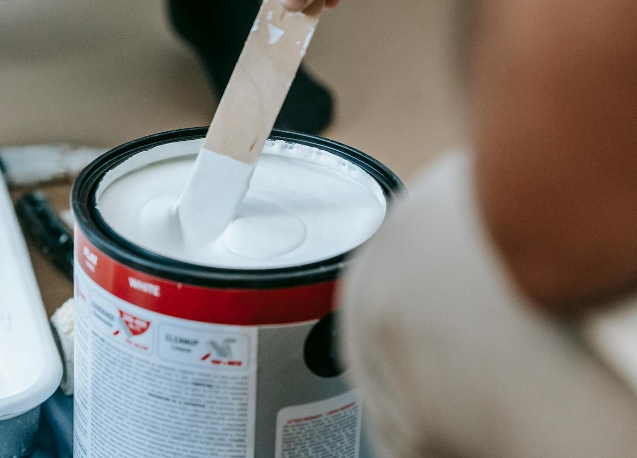 Person Mixing A Can Of Paint