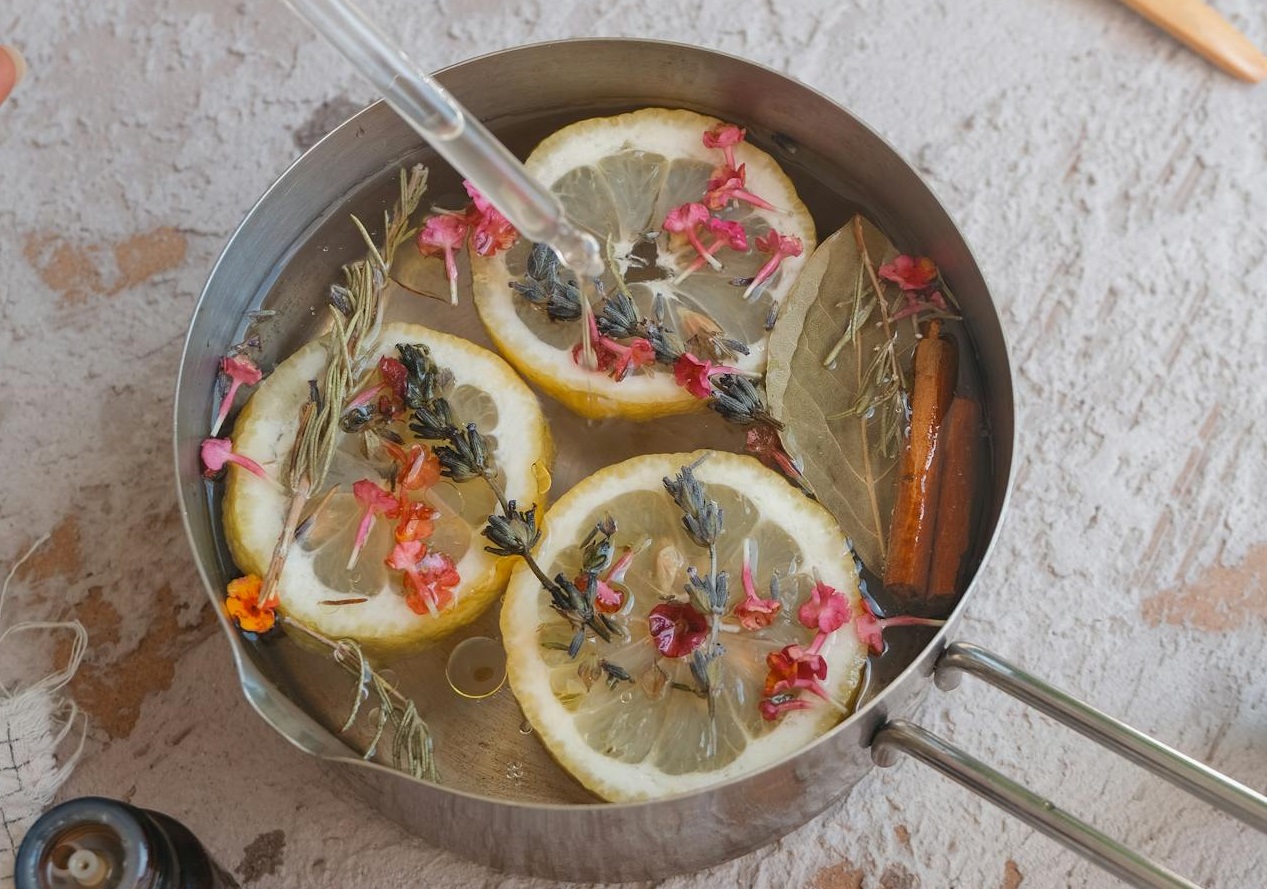 Woman Holding Syringe over Pot with Lemon Slices