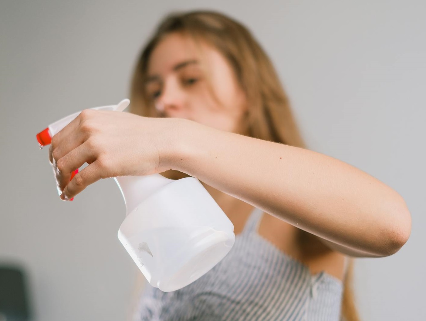 Female using spray bottle