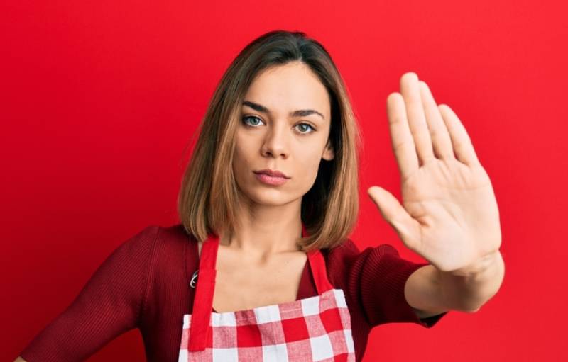 image of a woman saying stop sign with hand