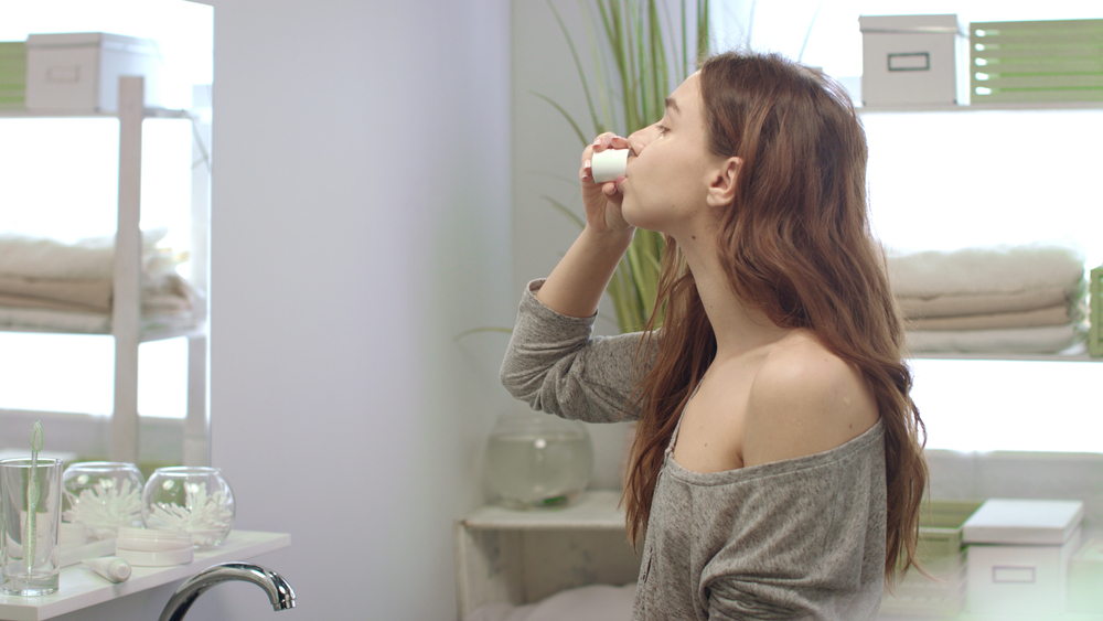 image of a woman mouth washing