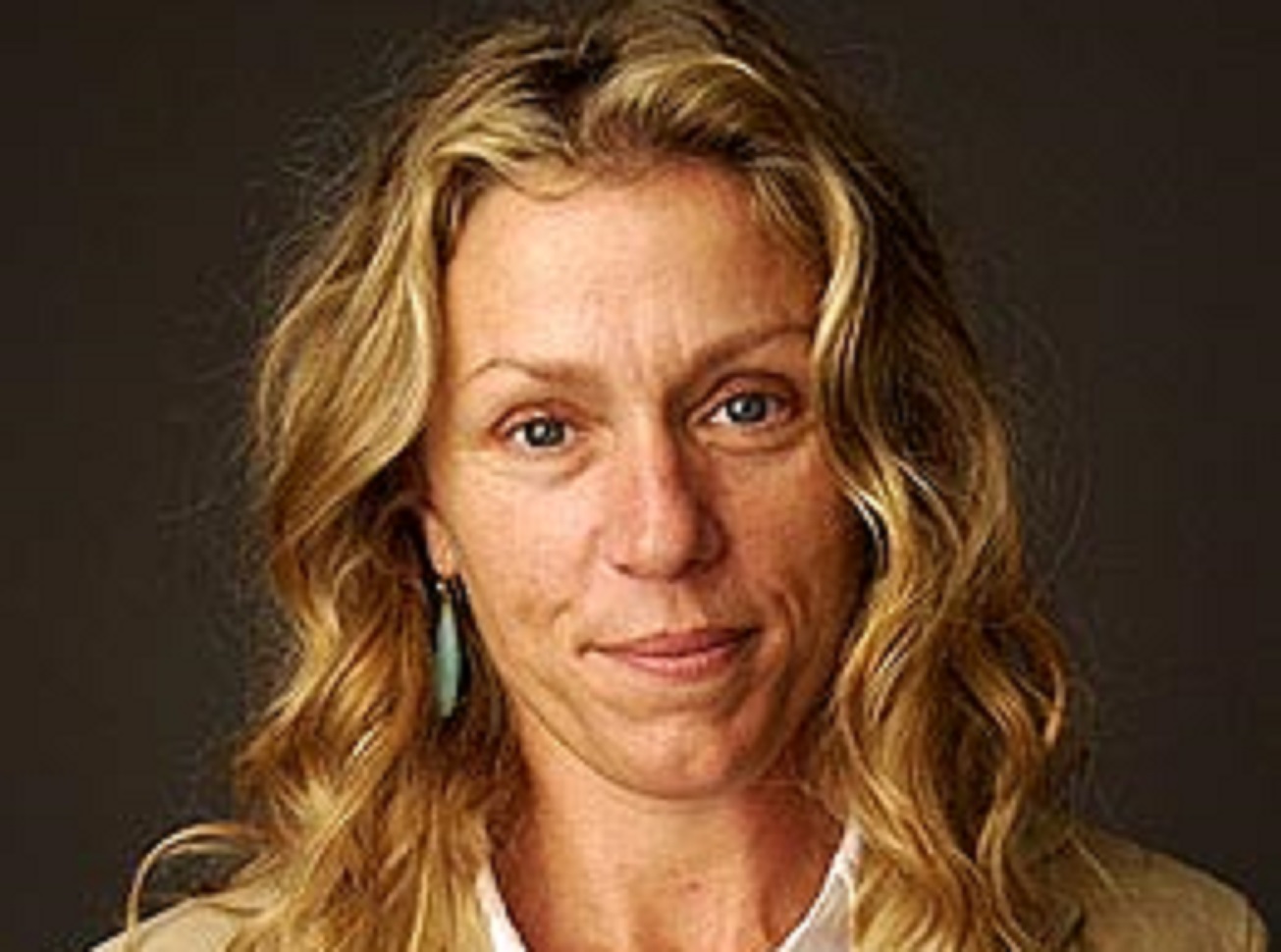 Frances McDormand smiling at camera.