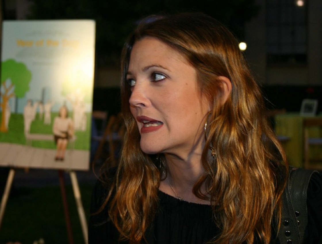 Drew Barrymore talking and looking at side.