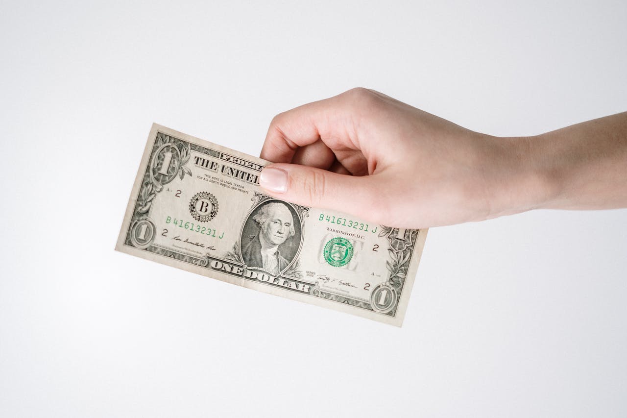 image of a person holding a dollar